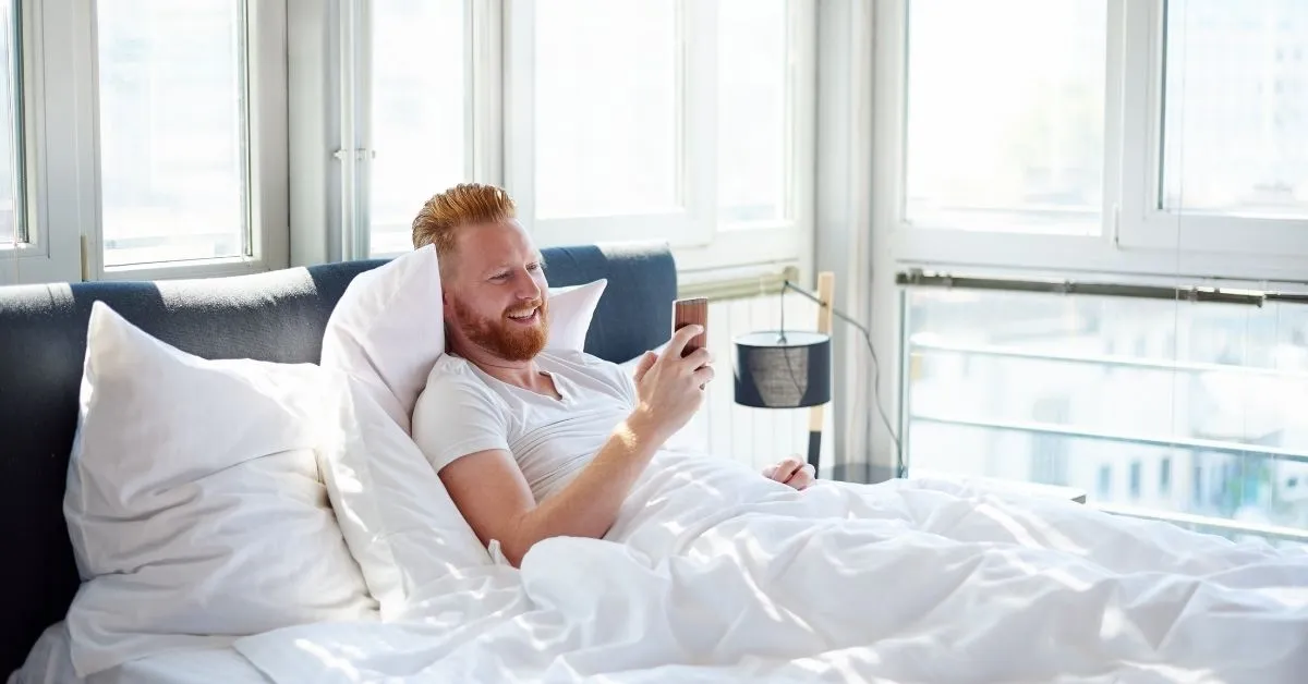 man on the phone in bed